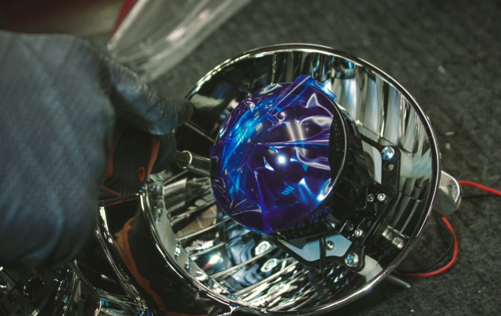 A car headlight in repair close up.