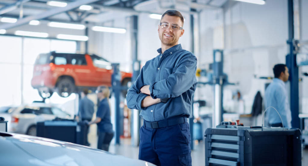 A service technician in his auto repair shop.